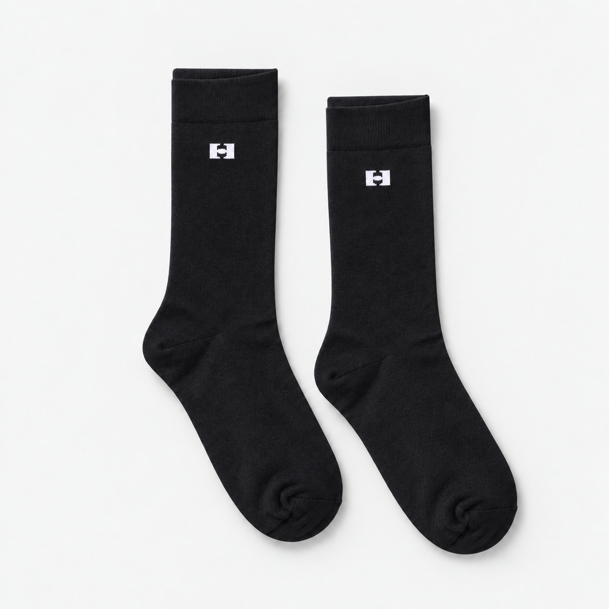 Par de meias pretas lisas com logo H jacquard branco no punho canelado